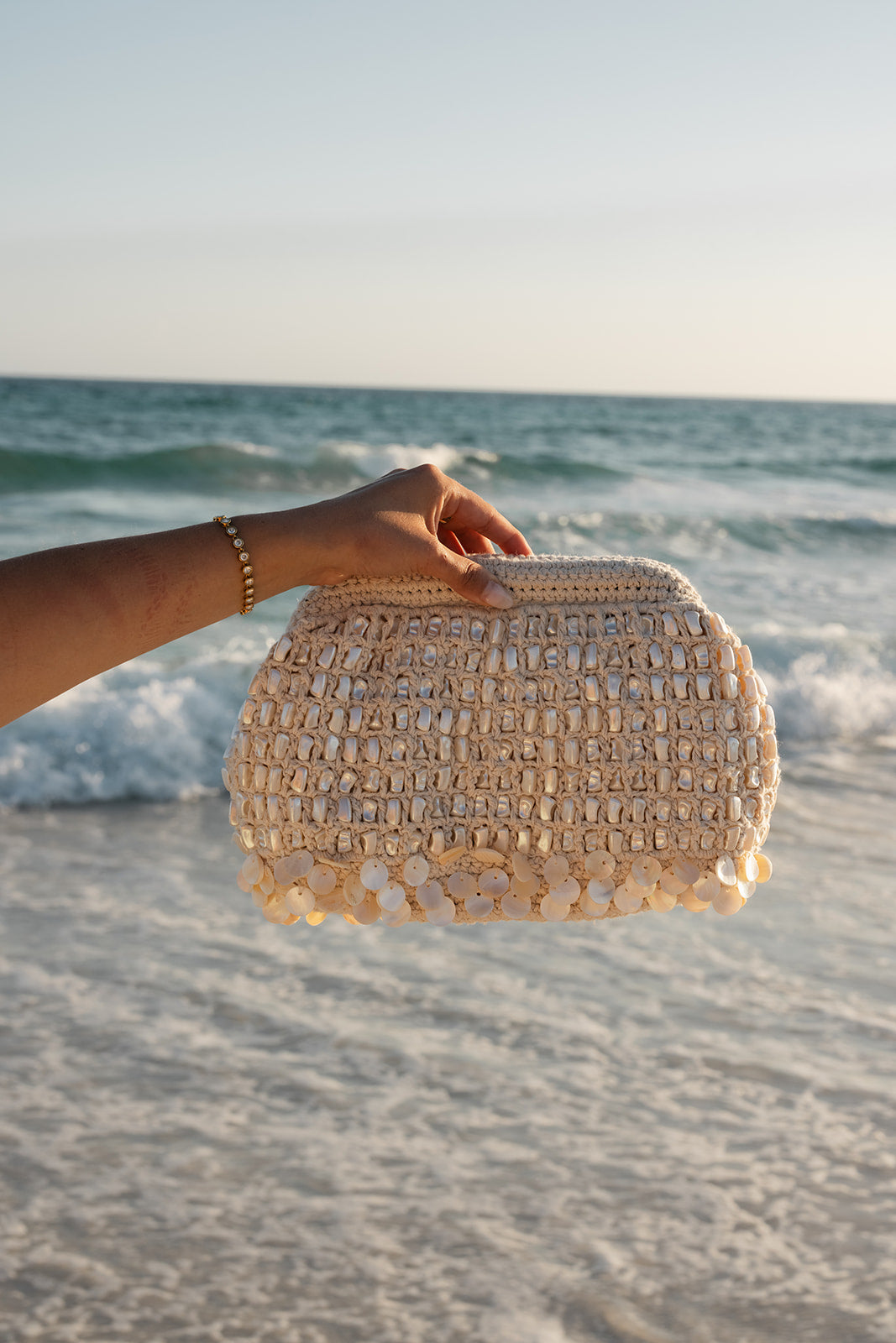 Coastal Muse Clutch on the beach